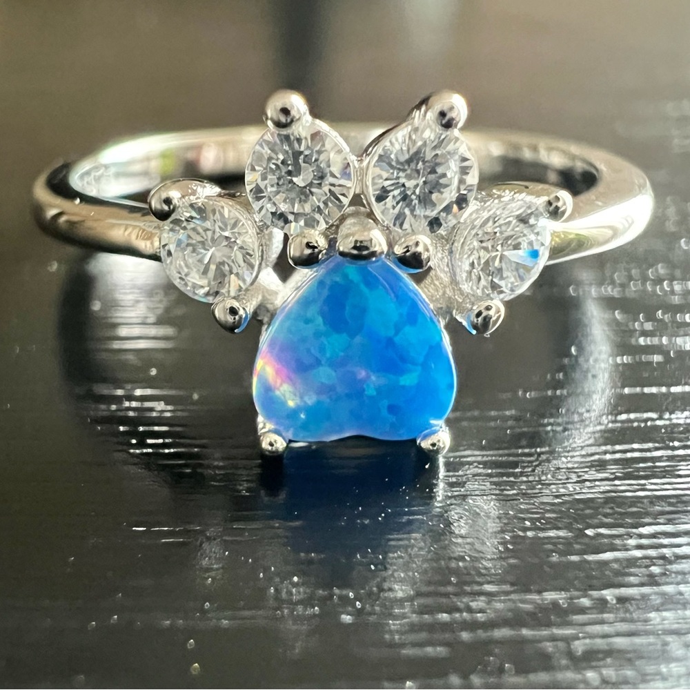 Blue Fire Opal Paw Ring in various sizes.